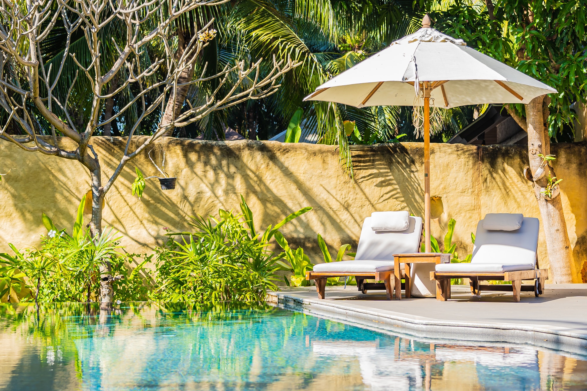 umbrella-and-chair-around-outdoor-swimming-pool.jpg