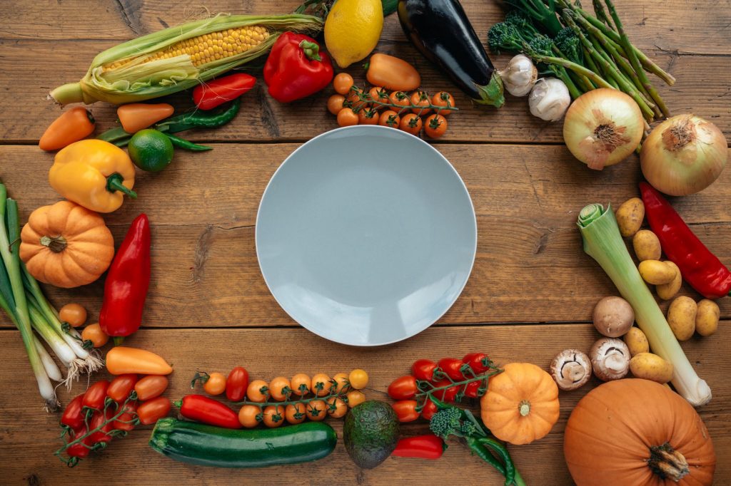 fresh healthy vegetables composed on table with white plate